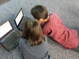 2 kids on laptops